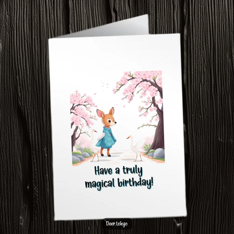Scenic free printable birthday card showing a deer in a blue kimono with cranes walking among cherry blossoms.